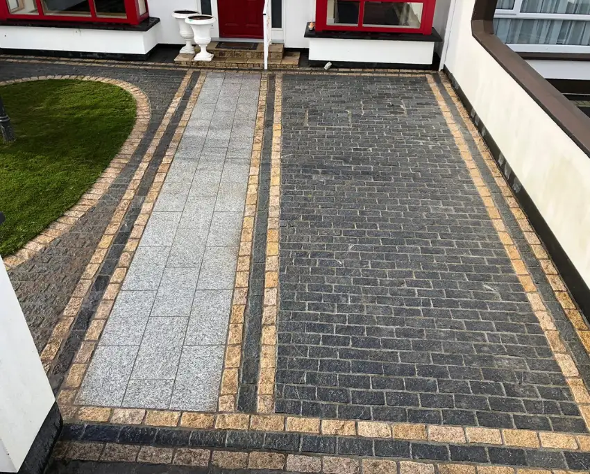 Soft curves with granite, cobble lock, and greenery